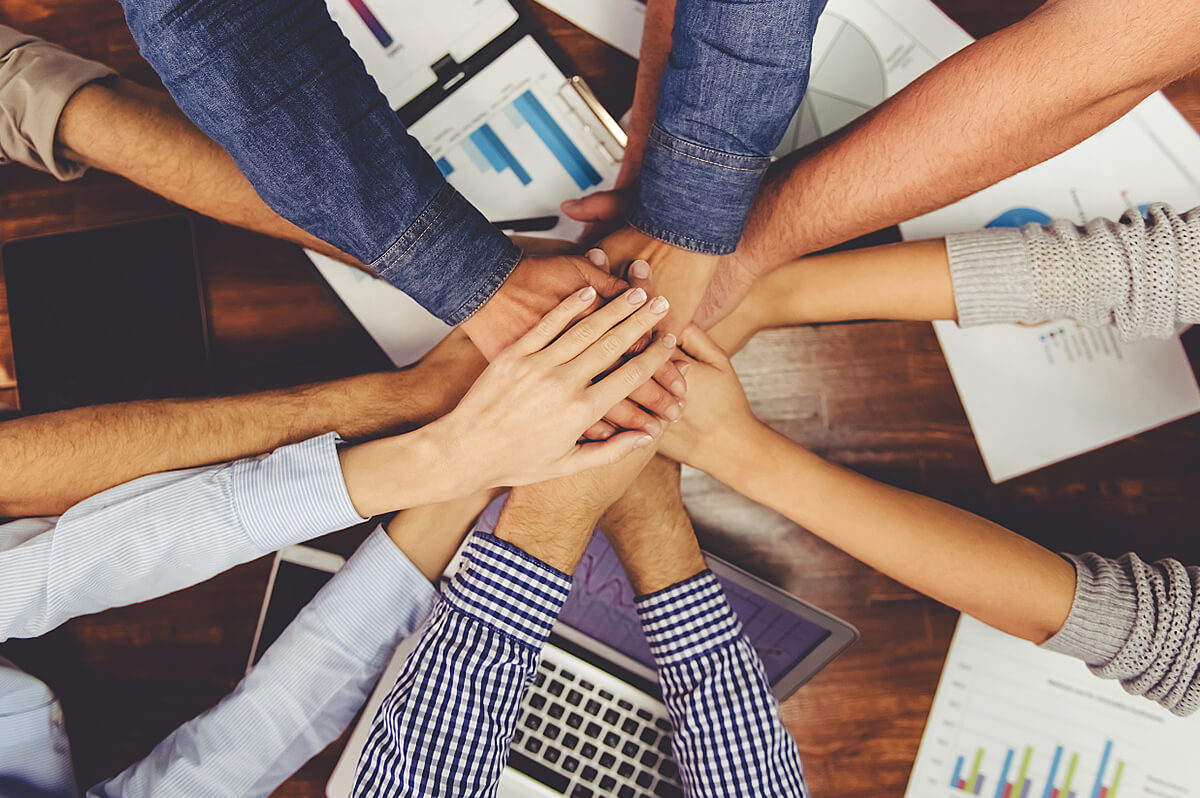 Close Up of Hands Stacked In Team Huddle