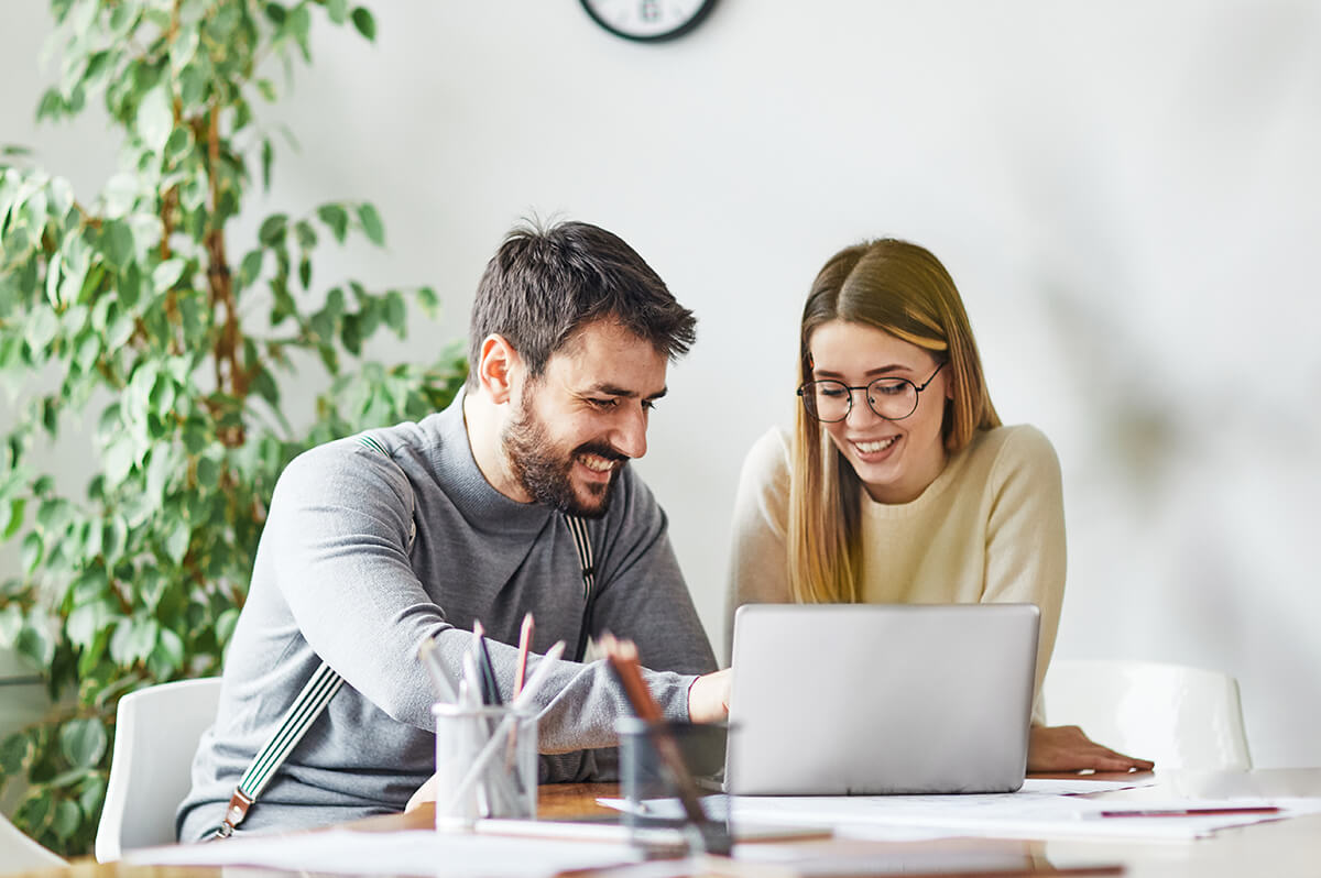 Man and woman sitting together in front of a laptop